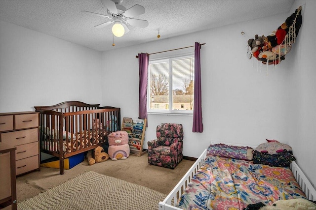 carpeted bedroom with a textured ceiling and ceiling fan