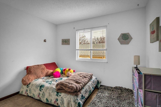 carpeted bedroom featuring a textured ceiling