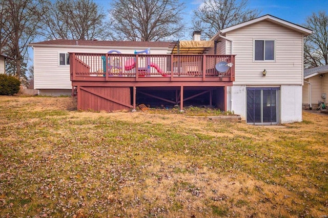 rear view of property featuring a deck and a yard