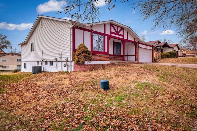 view of front of property with central AC and a garage