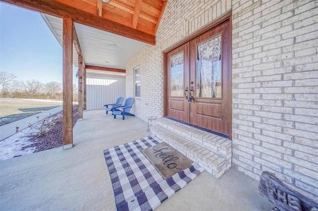 property entrance featuring french doors and a porch