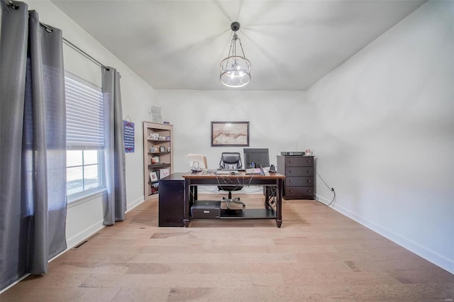 office space featuring a notable chandelier and light hardwood / wood-style floors