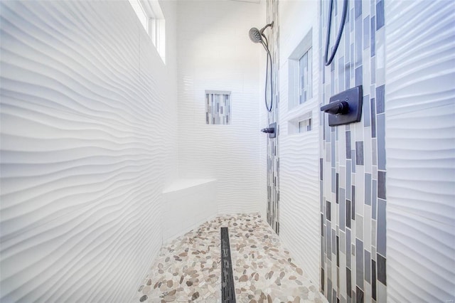 bathroom with a tile shower