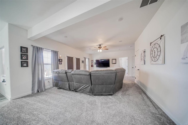 living room featuring beam ceiling, carpet floors, and ceiling fan