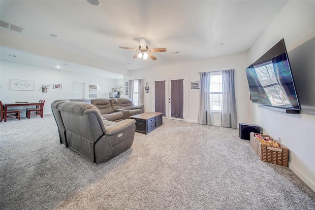 carpeted living room featuring ceiling fan