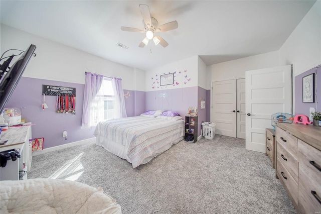 carpeted bedroom featuring ceiling fan and a closet