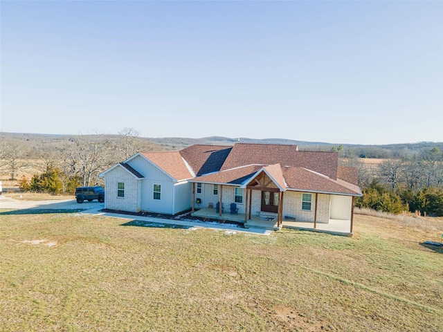 single story home featuring a front yard and a patio area