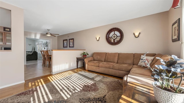 living room featuring ceiling fan and hardwood / wood-style flooring