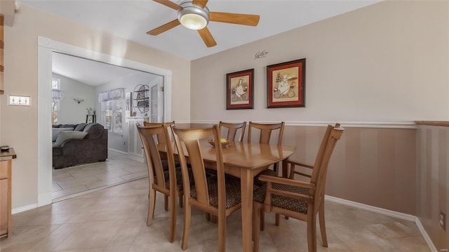 dining area featuring light tile patterned floors, vaulted ceiling, and ceiling fan