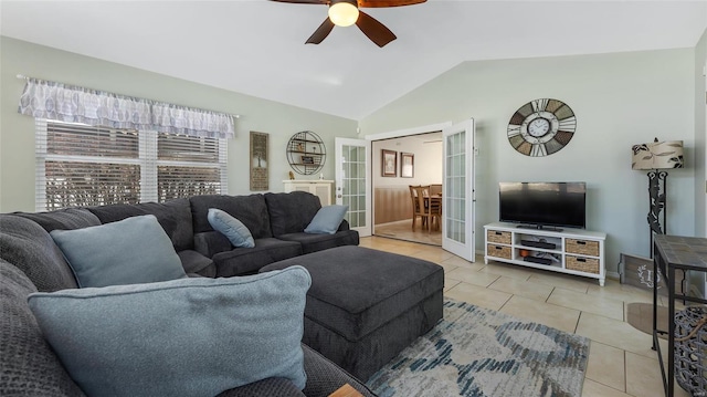 tiled living room featuring ceiling fan, lofted ceiling, and french doors