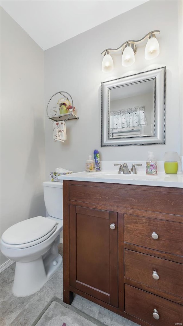 bathroom featuring tile patterned floors, vanity, and toilet