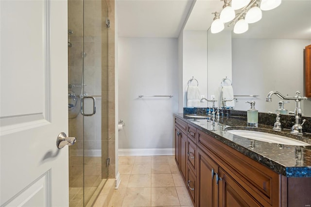 bathroom with tile patterned floors, vanity, and a shower with shower door