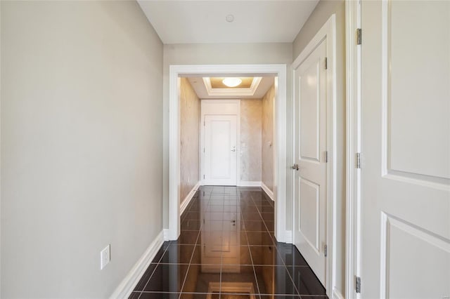 hallway featuring dark tile patterned flooring