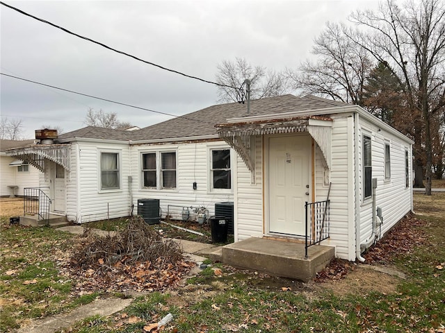 rear view of house with central AC unit