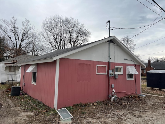 view of side of home with central AC