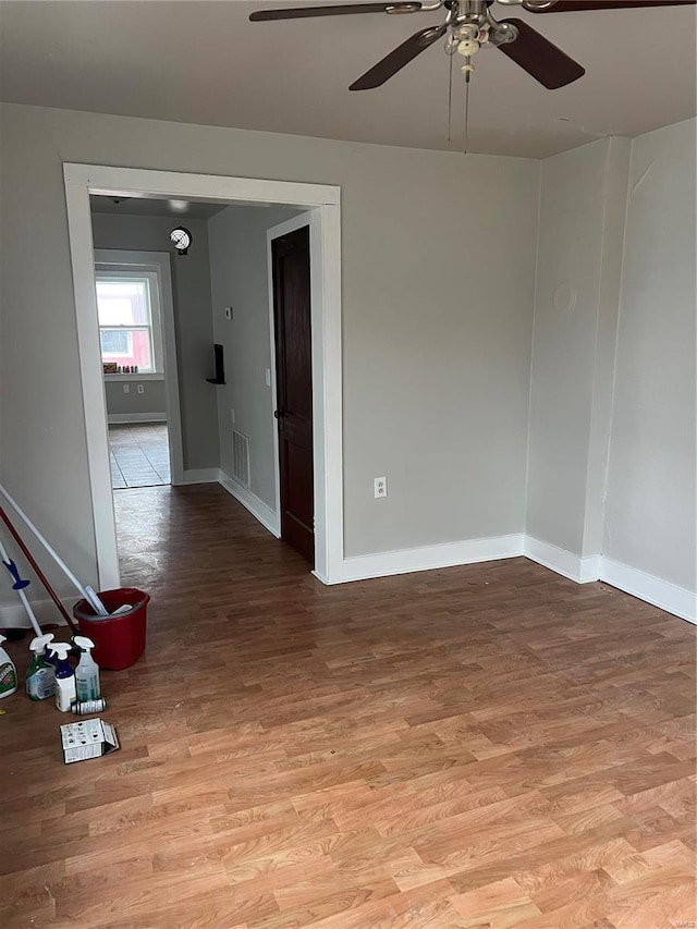 empty room with light hardwood / wood-style floors and ceiling fan