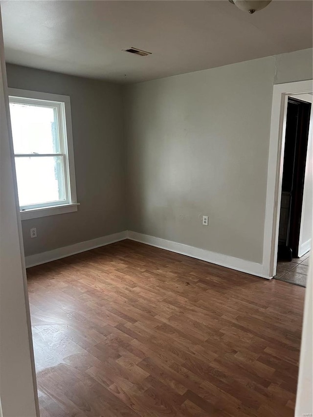 spare room with hardwood / wood-style flooring