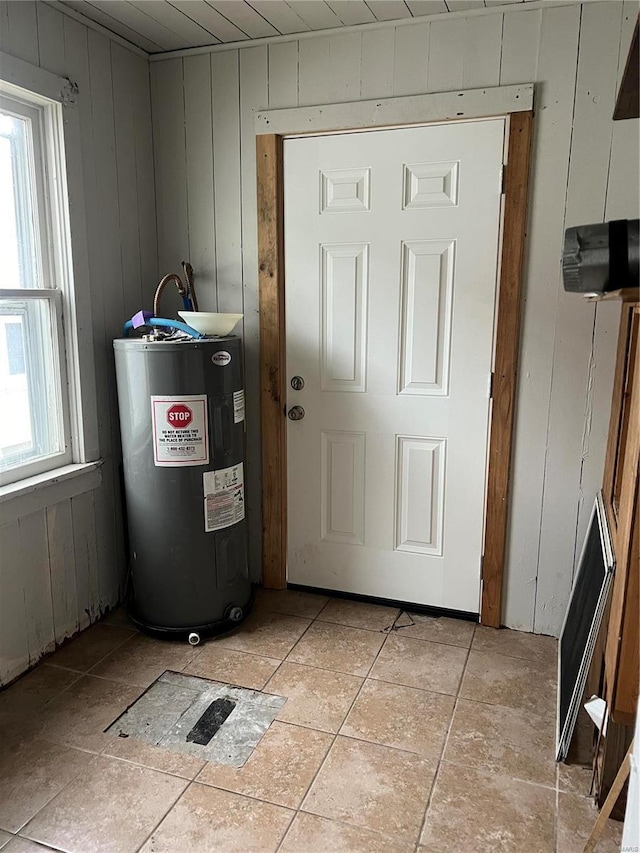 utility room featuring water heater