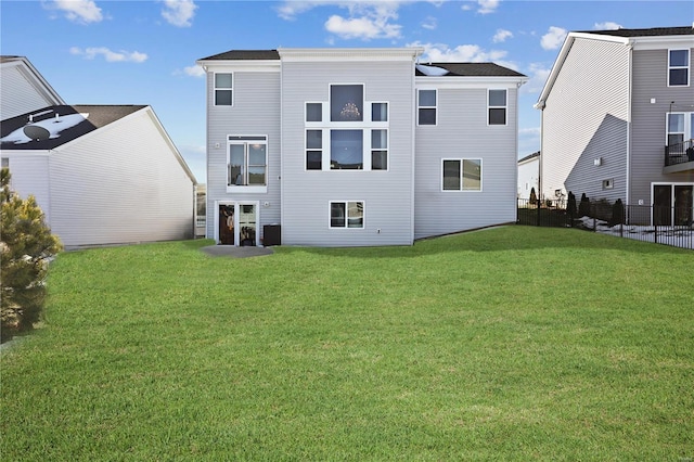 rear view of house featuring a lawn