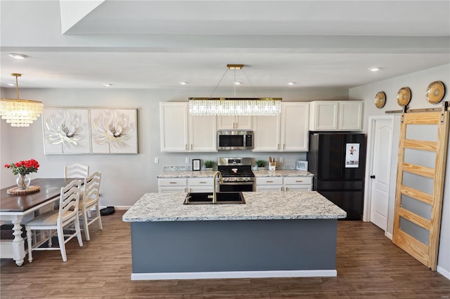 kitchen with dark wood-style floors, stainless steel appliances, and white cabinetry