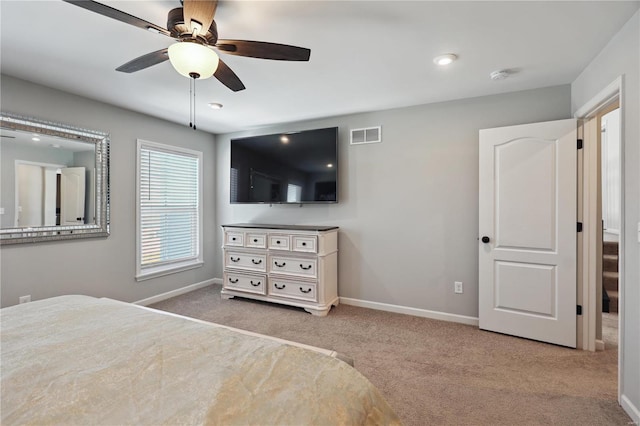 carpeted bedroom featuring baseboards, visible vents, and ceiling fan