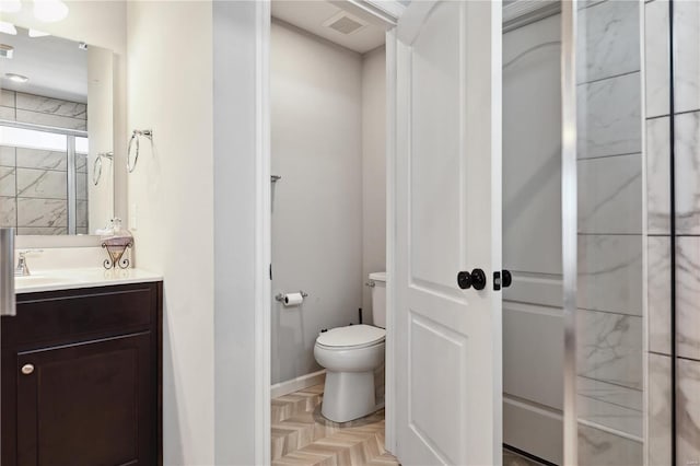 bathroom featuring toilet, visible vents, and vanity