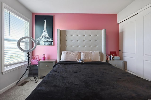 carpeted bedroom with visible vents and baseboards