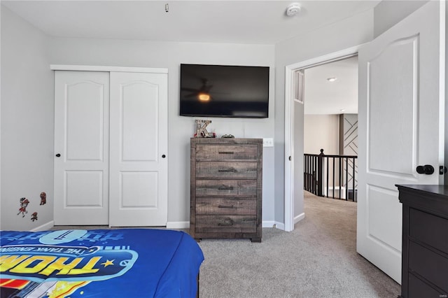 bedroom with a closet, carpet flooring, and baseboards