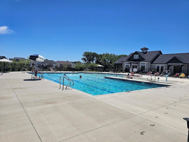 pool featuring a patio and fence