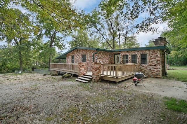 back of property featuring a deck