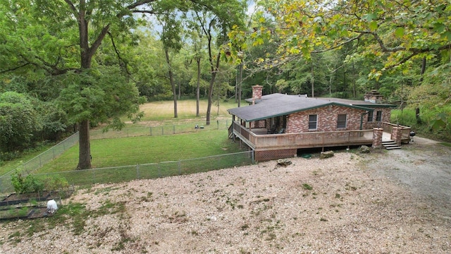 exterior space featuring a front lawn and a deck