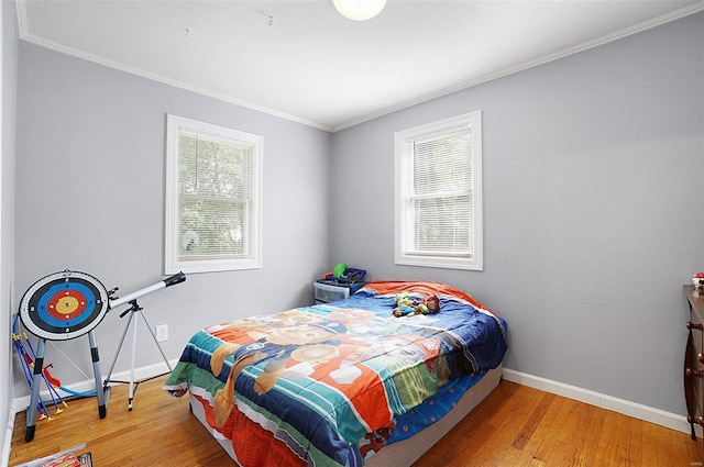 bedroom with hardwood / wood-style flooring and crown molding