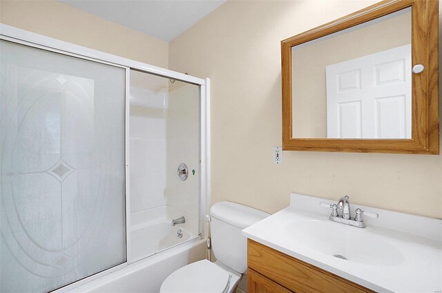 full bathroom with vanity, toilet, and bath / shower combo with glass door