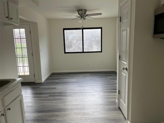 interior space featuring ceiling fan and dark hardwood / wood-style floors