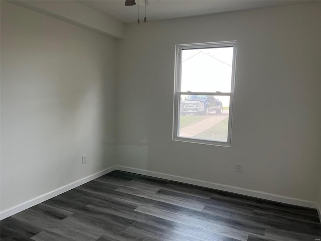 empty room with ceiling fan and dark hardwood / wood-style flooring