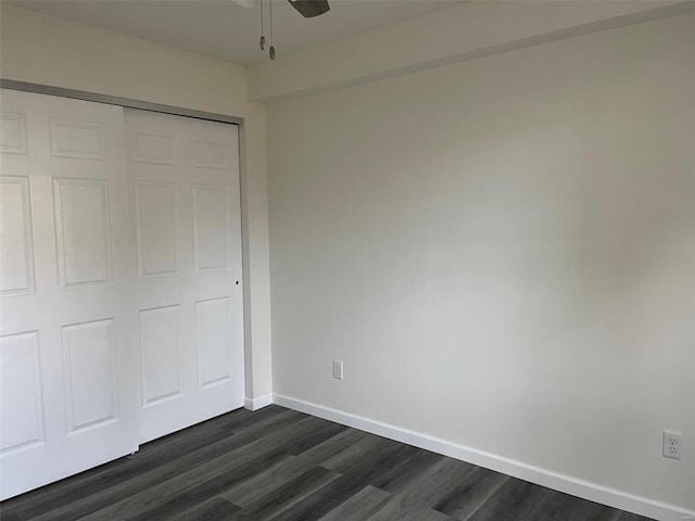 unfurnished bedroom featuring a closet, dark wood-type flooring, and ceiling fan