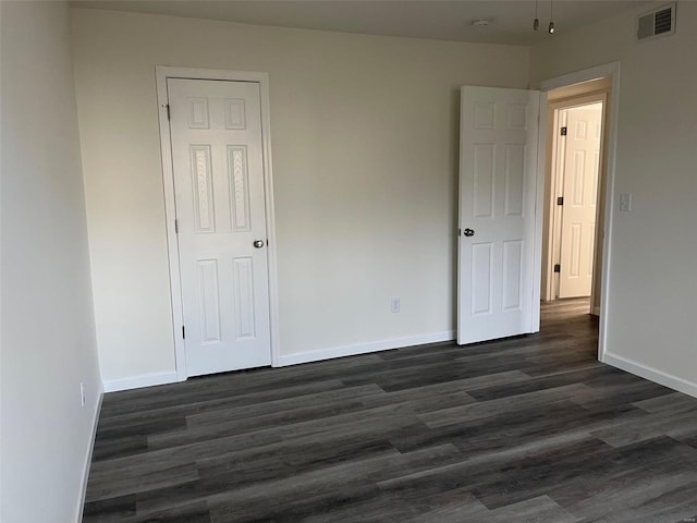 empty room with dark wood-type flooring