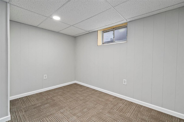 basement with carpet flooring and a paneled ceiling