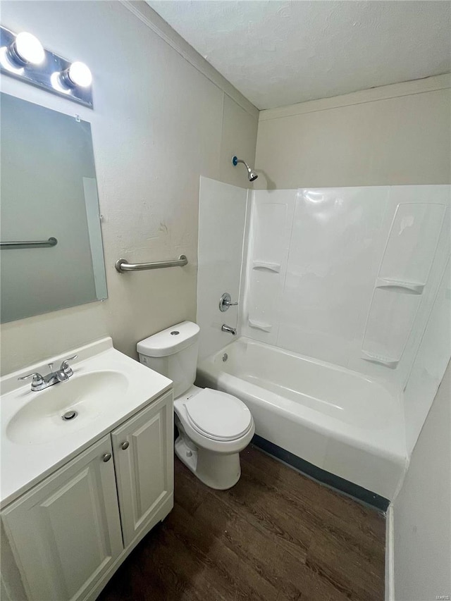 full bathroom featuring vanity, crown molding, hardwood / wood-style flooring, toilet, and shower / bath combination