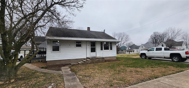 bungalow-style house featuring a front lawn