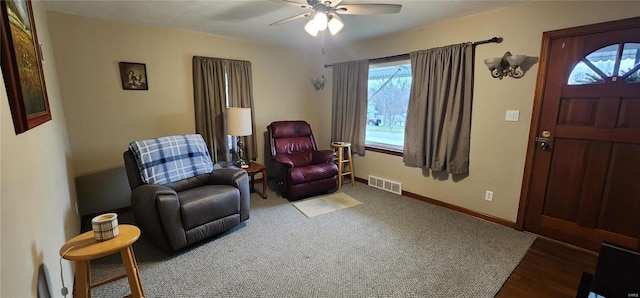 living area featuring ceiling fan