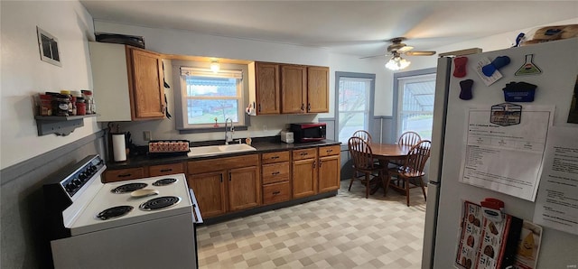 kitchen with ceiling fan, white appliances, and sink