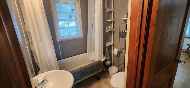 full bathroom with sink, shower / bath combo, and toilet