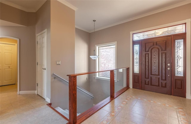 foyer with light tile patterned floors and crown molding