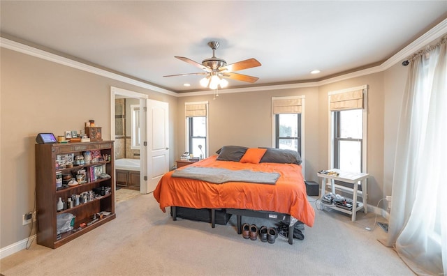 bedroom with connected bathroom, light carpet, ceiling fan, and crown molding