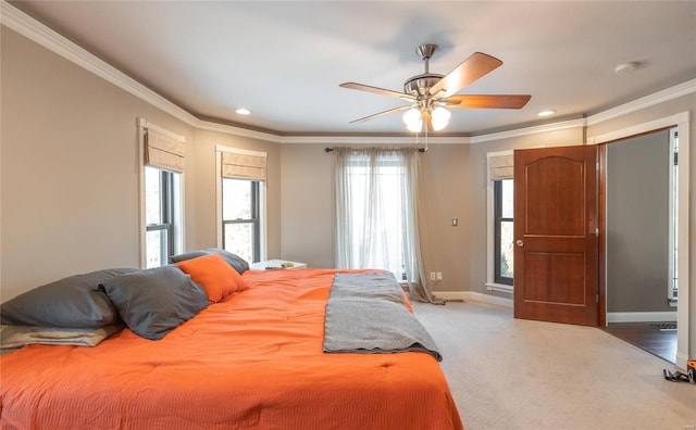 carpeted bedroom featuring ceiling fan and crown molding