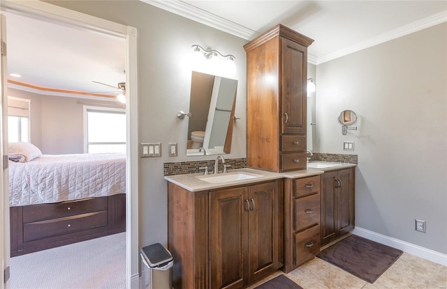 bathroom featuring toilet, crown molding, vanity, ceiling fan, and backsplash