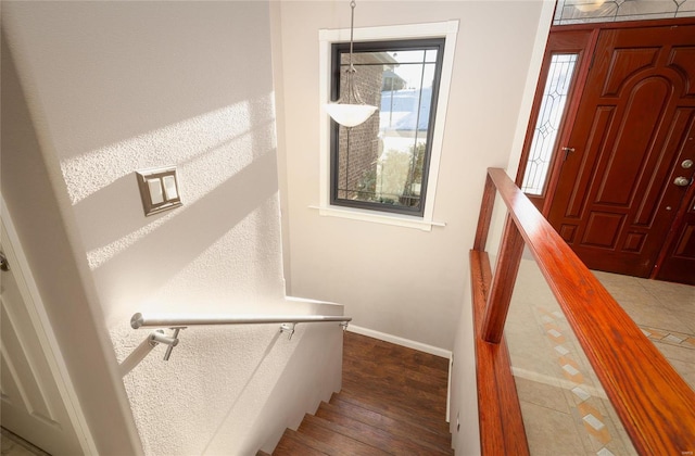 stairway featuring wood-type flooring