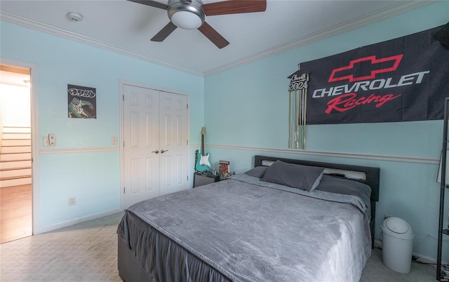 bedroom featuring a closet, ceiling fan, and crown molding