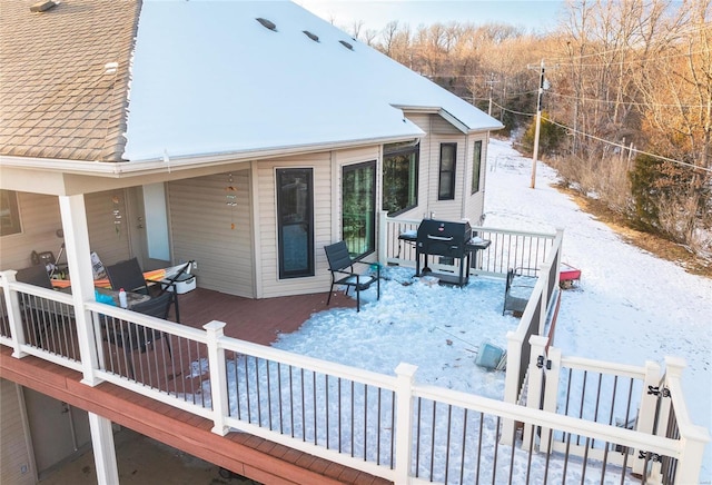 snow covered deck featuring grilling area